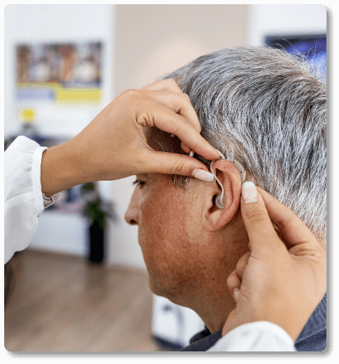 mature man getting fitted for a hearing aid